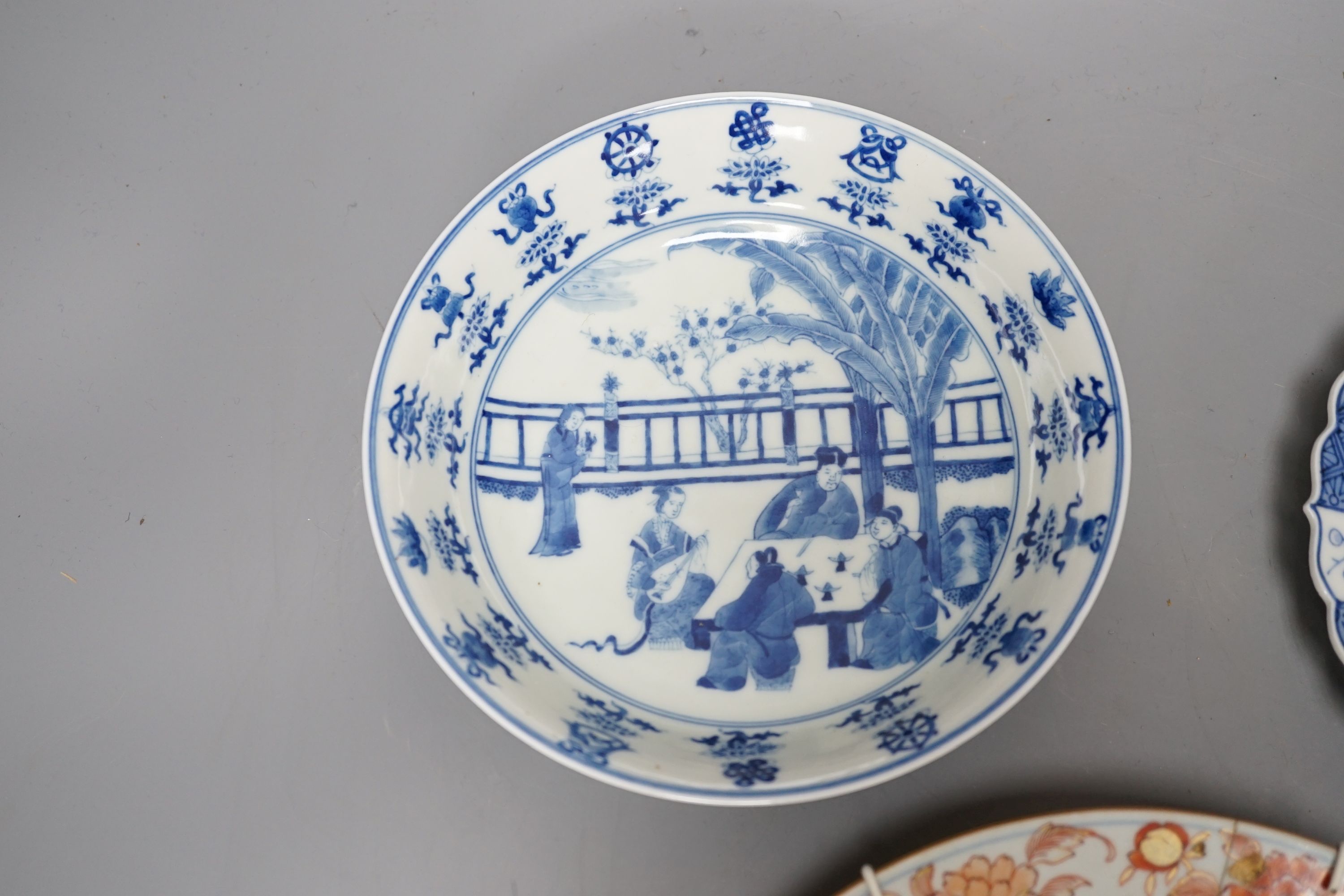 Three Chinese plates including a 19th century Chinese Imari dish, 23cm - repaired, a Chinese famille rose crackleglaze vase, 29cm, together with a famille rose teapot and a crackleglaze celadon ground bottle vase. Talles